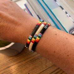 Skies are blue! These sweet rainbow bracelets for women will bring a much-needed smile after the rain. Perfect for women who love the joy of rainbows or as a memorial of a special loved one. Look — the clouds are parting!+ glass tile beads + two stretch cords+ finished with gold-plated beads (lead-free and nickel-free)+ 7" (fit most adult wrists)+ packaged in a clear resealing bag for storage and gift givingAVAILABLE STYLES+ Ivory/Rainbow+ Black/RainbowBUY MORE, SAVE MORE!Buy 2 or 3 and save! Ne Multicolor Resizable Braided Bracelets For Everyday, Resizable Multicolor Braided Bracelets For Everyday, Everyday Multicolor Resizable Bracelet, Resizable Rainbow Beaded Friendship Bracelets, Rainbow Resizable Beaded Bracelets For Friendship, Everyday Resizable Multicolor Friendship Bracelets, Multicolor Friendship Bracelets With Sliding Knot For Everyday, Adjustable Rainbow Friendship Bracelets With Colorful Beads, Adjustable Rainbow Friendship Bracelets With Letter Beads