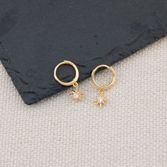 Introducing our 14K gold/ sterling silver huggie hoops with tiny celestial charm! They feature sun / starburst charm and are the perfect minimalist accessory to wear every day. The delicate and lightweight design will ensure you feel comfortable all day long. Made with high quality 925 sterling silver with 14 K gold filled finish. - Dimension:  21.5 mm x 5 mm / Huggie inner diameter: 11 mm - Hypoallergenic, Solid 925 sterling silver, Platinum or 14 K gold filled finish  - Turnaround time: Same day or Next day delivery guaranteed  - Qty: 1 pair - Packed in gift jewelry box with ribbon and wax stamp  - Please ask me any questions ! I am quick to reply :) Thank you for visiting my shop  - For shop policies, please visit: https://www.etsy.com/shop/DoodleJewelrybyDKArt Minimalist Accessories, Wax Stamp, Star Gift, Jewelry Sterling Silver, Huggie Hoop Earrings, Gift Jewelry, Jewelry Earrings Hoops, Jewelry Gift Box, Shop Policies