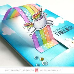 a close up of a card with a unicorn on it's head and rainbows in the background