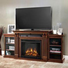 an entertainment center with a fireplace and television