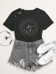 a pair of white sneakers and a black shirt with the sun and moon on it