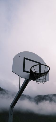 a basketball hoop in the middle of a foggy field