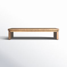 a wooden bench sitting on top of a white floor