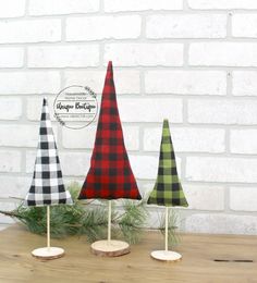 three wooden christmas trees sitting on top of a table