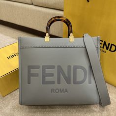 Description FND Tote Bag Grey For Women, Wonmen’s Bags 13.8in/35cm FF 8BH386ABVLF1BZC Rep 1:1 Medium Sunshine Shopper bag grey with hot-stamped “FND ROMA” and stiff tortoiseshell plexiglass handles. Equipped with a spacious lined internal compartment. Size 35 x 17 x 31 cm / 13.8 x 6.7 x 12.2 inches (Length x Height x Width) Gray. Gold-finish metalware The two handles and detachable shoulder strap. Can be carried by hand or worn on the shoulder. Include dust bag. This product is of the best quali Fendi Tote Bag, Fendi Tote, Longchamp Bag, Fendi Bag, Celine Bag, Shopper Bag, Sierra Leone, Fendi Bags, Sling Bag