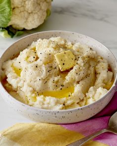 a bowl filled with mashed potatoes and topped with cheese