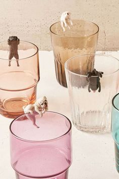 several glasses with small figurines on them