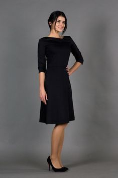 "An asymmetrical dress featuring fit and flare silhouette, midi length, and 3/4 sleeves. - asymmetrical v-neck - 3/4 sleeves - flared skirt with inverted front pleat - fit and flare silhouette - midi length - extraordinary dart in the front - concealed back zipper closure Color: dark blue Fabric: cotton - 95%, elastane - 5% For Size S (6 US): dress length - 40\" (101 cm), sleeve length - 15,3\" (39 cm) Our model wears size S (06) and is 171 cm/5'6\" tall Model in the photo: 64,5\" (164 cm) heigh Casual Skater Dress, Modest Black Dress, Italian Costume, Skater Dresses Casual, Flare Dress Casual, Tea Length Bridesmaid Dresses, Mandarin Collar Dress, Midi Bridesmaid Dress, Elegant Cocktail Dress