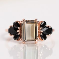 smoky quartz & Black Onyx Ring-Emerald Cut Smoky quartz Ring-Solitaire Ring-Multistone Ring-14K Gold smoky quartz Ring-Anniversary Ring- Add a bit of mystical magic to your ring stack with this stunning rose gold ring from Mehroon. Featuring a bold labradorite gemstone offset by mysterious black onyx crystals on a pretty rose gold brand. Smoky quartz 8 x 6 mm Black onyx 3 - 5 mm 14k rose gold vermeil plated Sterling silver base Band width 1.3 mm Care Instructions Gold Vermeil & Gold Plated To extend the life of your gold plated and vermeil jewelry, avoid wearing when washing hands, showering, applying lotion, using harsh cleaning supplies or working out. To clean, buff gently with a soft and dry 100% cotton cloth or a microfiber cloth. Do not use jewelry cleaner on gold plated jewelry. Fre Multistone Ring, Onyx Crystal, Washing Hands, Smoky Quartz Ring, Ring Emerald, Black Onyx Ring, Vermeil Jewelry, Gold Branding, Onyx Ring