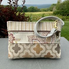 "Medium Size Wristlet. Neutral Color Wristlet with a Pearl Gray Leather Strap. Super Quality Industrial Upholstery Fabric. Large front zip pocket. Top zip opens to roomy interior. There's one inside pocket big enough for your credit cards,plus a large pocket that will fit a phone(or you could put it in the outside pocket ...)AND there's a clip off key ring 8.5\" wide 6\"deep 1 1/4\"bottom Use as your only bag, or use like a wallet and carry in a bigger bag. Great for an Evening bag , or when you Coin Purse Clutch With Wrist Strap, Clutch Bags With Wrist Strap As Gifts, Everyday Clutch Pouch With Wrist Strap, Everyday Handheld Pouch With Wrist Strap, Everyday Pouch Clutch With Wrist Strap, Beige Mobile Phone Clutch Bag, Everyday Clutch With Wrist Strap, Rectangular Cream Pouch With Zipper Closure, Beige Mobile Phone Clutch