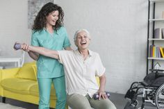 a nurse helping an elderly woman with her walker's cane in a living room