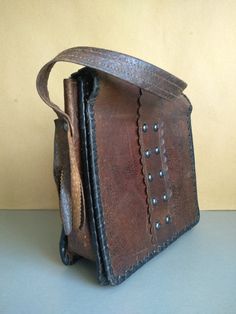 Vintage Bag Of Genuine Calfskin - Retro leather bag - Old leather bag from 60' - brown leather bag - Genuine Leather Bag - Shoulder bag The old bag has traces of use. Dimensions : The length of the handle / strap / - 58 centimeters 22 cm x 23 cm x 7 cm For other vintage bag check here : https://www.etsy.com/shop/TheVINTAGEShopBG?ref=l2-shop-info-name&section_id=22456024 FAST SHIPPING ! Possible express delivery with DHL but please first ask me for price . All pictures are real . You buy exac Brown Leather-handled Crossbody Box Bag, Brown Leather Travel Box Bag, Vintage Brown Bag For Everyday Use, Brown Leather Saddle Shoulder Bag, Brown Leather Hobo Shoulder Bag, Vintage Brown Satchel Bag, Vintage Textured Leather Bags, Vintage Leather Bag With Leather Backing, Brown Leather Saddle Bag With Leather Lining