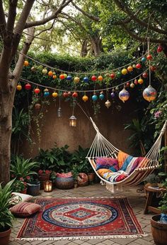 a hammock in the middle of a garden with potted plants and hanging lanterns