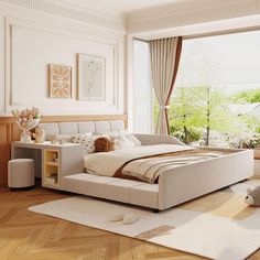 a large white bed sitting in the middle of a bedroom next to a wooden floor