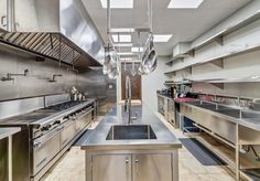 an industrial kitchen with stainless steel appliances and counters