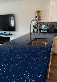 a blue counter top in a kitchen next to a tv