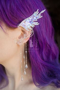 Magical fairy ear cuffs with sparkling glass beads and snow flakes crafted in silver plated wire and angelina film. The film is very iridescent, so the color may vary depending on viewing angle and lightning. The ear cuffs are very easy to wear. They are designed to hook over the back of your ear like a Blue Tooth device and can be gently shaped to perfectly fit your ear. No piercing needed. They are very light in weight. Wear it to your favorite Festival, Fair, Comic Con, costume ball. Perfect Silver Fantasy Ear Cuff For Party, Fantasy Silver Ear Cuff For Party, Fairy Style Ear Cuff For Party With Pierced Ears, Fairy Style Ear Cuff For Party, Whimsical Adjustable Silver Ear Cuff, Adjustable Silver Whimsical Ear Cuff, Silver Fantasy Style Ear Cuff For Gift, Silver Fantasy Style Ear Cuff As Gift, Silver Wire Wrapped Ear Cuff For Party