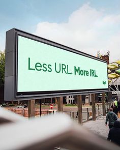 there is a large sign that says less url moreil on the side of the street