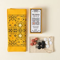 an assortment of buttons and other items are laid out on a white surface next to a yellow cloth