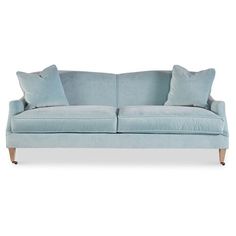 Designed with a kiln-dried hardwood frame, subtly rolled arms, and brass casters on its two tapered front legs, this cotton-blend velvet sofa makes an elegant addition to your space. A feather-and-down fill ensures long-lasting comfort and support. Handcrafted in the USA. Light Blue Sofa Living Room, Light Blue Couches, Blue Velvet Sofa Living Room, Light Blue Sofa, Blue Velvet Couch, Blue Sofas Living Room, Velvet Sofa Living Room, Blue Velvet Sofa, Luxury Furniture Living Room