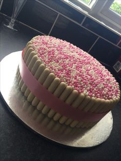 a cake with pink and white frosting on top