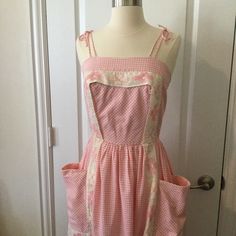 Vintage 60s Pink And White Gingham Dress. Thick Organza-Like Trim /Apron Detail. Fit And Flare Style With Gathered Skirt. Zips Up Center Back With A Nylon Zipper. Has Small Hole In Fabric On Front Bodice, See Pic. It Is Small And Is 1.75” Above Waistline. A Thick Belt Can Hide This. Zipper Has Some Loose Stitching, Looks Like It Was Redone At Some Point, It Can Benefit From Some Extra Stitches That I Have Not Done. Top Bodice Is Fully Lined With Same Gingham Fabric. Very Good Condition And Freshly Laundered! Measurements Bust 32-32.5” Side Seam To Side Seam Length 31.5” Top Side Seam To Hem Shoulder Straps Tie At Top Of Shoulder.. Retro Gingham Vintage Dress, Retro Gingham Dress For Picnic, 1950s Style Gingham Dress For Picnic, Spring Retro Gingham Dress, 1950s Style Gingham Cotton Dress, Fitted Gingham Cottagecore Dress, Vintage Gingham Dresses With Square Neck, Retro Gingham Cotton Vintage Dress, Retro Gingham Vintage Dress In Cotton