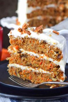 a slice of carrot cake on a plate with a fork