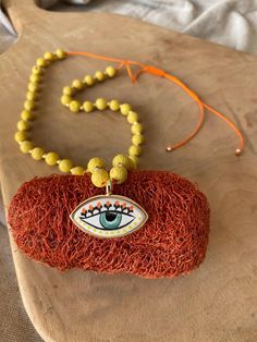 The ceramic at the end is specially designed and hand painted. The length can be adjusted thanks to the macrame I made at the end of the necklace. Enjoy your shopping ️ This handmade necklace features a striking combination of yellow lava stones and a ceramic evil eye charm, offering both style and protection. The earthy texture of the lava stone complements the smooth ceramic, creating a unique and meaningful accessory. Perfect as a protective talisman or a thoughtful gift for someone special, Ceramic Evil Eye, Lava Stone Jewelry, Protective Talisman, Handmade Evil Eye, Eye Gift, Protection Jewelry, Yellow Stone, Evil Eye Charm, Evil Eye Necklace