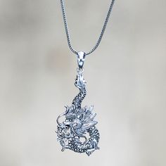 Poised on a sterling chain a dragon in all its splendor is a protective creature in Bali. Nyoman Rena transforms the creature into a wonderfully detailed pendant necklace. .925 Sterling silver Novica Jewelry, Mystical Dragon, Necklace Displays, Paw Print Jewelry, Ribbon Jewelry, Dragon Earrings, Necklaces Pendant, Printed Jewelry, Dragon Pendant