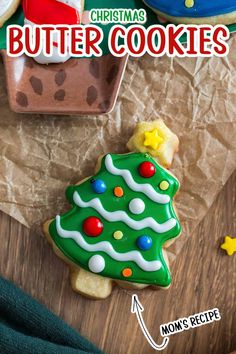 a cookie decorated like a christmas tree sitting on top of a table next to other cookies