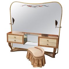 an antique dresser with mirror, stool and bird motif on the top part of it