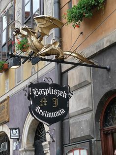 a sign for a restaurant with a gold dragon on it's front and side