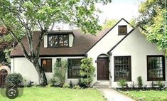 a white house with brown trim and windows