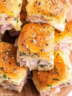 ham and cheese sliders stacked on top of each other in a wooden platter