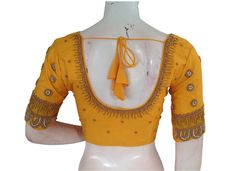 Make a Statement With this yellow color semi silk blouse, adorned with intricate Aari hand embroidery! This stunning piece combines traditional Indian techniques with modern style. Perfect for special occasions or adding a touch of elegance to your everyday look. * This Is A Fully Stitched Saree Blouse, Ready To Wear * Made of Semi silk, Lined With Cotton * Opens From Front With Hook and eye-fitting MEASUREMENTS: Sleeve: 10 inches  Size: 38,40,42 Blouse Length: 15.5 inches  Neck depth: 7.5 inche Elegant Designer Yellow Blouse Piece, Yellow Blouse With Zari Work In Traditional Drape, Traditional Yellow Blouse With Zari Work, Yellow Blouse With Traditional Drape For Diwali, Yellow Traditional Drape Blouse For Diwali, Traditional Drape Yellow Blouse For Diwali, Festive Yellow Blouse With Traditional Drape, Festive Yellow Traditional Drape Blouse, Semi-stitched Silk Yellow Blouse Piece