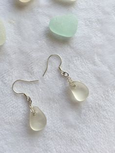 one pair of beautiful unique handmade S925 sterling silver  dangle earrings with water drop shape sea glass, each piece of sea glass I use is genuine sea glass was carefully hand collected from Seaham beach in North east England.  The earring total length is 3.4cm, the Sea glass size around 1.5cm.  All the finished jewellery come with beautiful box ready to be a gift to your care and love one.  PLEASE NOTE: earrings are sold as a pairs. Due to the nature of sea glass, the pieces in each pair are not identical to each other, they have been carefully selected as close as possible to match in shape, colour and size.  . If you have any questions please message me. Silver Teardrop Earrings For Beach, Glass Teardrop Jewelry With Matching Earrings, Minimalist Glass Dangle Jewelry, Hypoallergenic Teardrop Earrings For Beach, Minimalist Teardrop Glass Jewelry, Sea Glass Teardrop Earrings As Gift, Elegant Jewelry With Sea Glass And Ear Wire, Minimalist Nickel Free Sea Glass Jewelry, Silver Glass Teardrop Jewelry