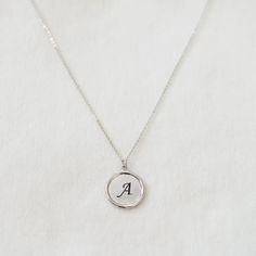 "These minimalist necklace make a contemporary, elegant addition to any ensemble! A custom engraved initial disc necklace would make a perfect gift for yourself and your loved ones. This beautiful and delicate necklace is the perfect layering or beautiful on its own. D E T A I L S - Embellished Disc with a slightly hammered surface - Disc size: 18mm x 18mm - Custom engraved initial - Handmade to order - This listing is for ONE necklace. - Each piece or set comes in a gift box, ready for gifting. Minimalist Hand Stamped Initial Necklace, Minimalist Silver Initial Pendant Necklace, Silver Minimalist Personalized Initial Necklace, Minimalist Silver Initial Necklace, Silver Minimalist Initial Necklace, Minimalist Silver Monogram Necklace, Minimalist Medallion Necklace For Mother's Day, Minimalist Round Disc Initial Necklace For Gift, Minimalist Round Disc Initial Necklace As Gift