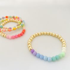 Pastels and gold? Yes, please! Our best-selling Gold Bead bracelet gets a pretty pop of color thanks to our pastel acrylic beads. Add to your stack or wear alone but either way, these bracelets will pretty up your arm party! Bracelet measures 7" in circumference. If you need a custom length, please send an email to hello@belleandten.com. Bracelets are made from gold plated base metal and acrylic. Playful Gold Beaded Bracelets For Everyday, Spring Gold Beaded Bracelets With Colorful Beads, Spring Gold Bracelets With Round Beads, Gold Round Beads Bracelets For Spring, Gold Round Beads Bracelet For Spring, Gold Bracelets With Round Beads For Spring, Playful Gold Bracelets With Colorful Beads, Trendy Pastel Beaded Bracelets, Gold Bead Bracelet