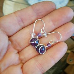 "These are 8mm (about 5/15\") amethyst beads that we cleverly wirewrapped in sterling silver. We topped it off with a 4mm amethyst bead for a cute little purple stone earring. The entire earring measures about 1 1/4\" (3.2cm) from the very top of the sterling silver earwire to the bottom of the earring. The earrings in the picture are a representative pair of earrings and not the exact same pair that you will receive. We try hard to chose beads and stones that look very similar to the ones pictu Purple Round Spiritual Earrings, Spiritual Round Purple Earrings, Spiritual Purple Round Earrings, Silver Amethyst Wire Wrapped Earrings, Lavender Wire Wrapped Jewelry For Gifts, Wire Wrapped Amethyst Round Earrings, Amethyst Wire Wrapped Round Earrings, Wire Wrapped Purple Jewelry Gift, Purple Amethyst Jewelry With Ear Wire