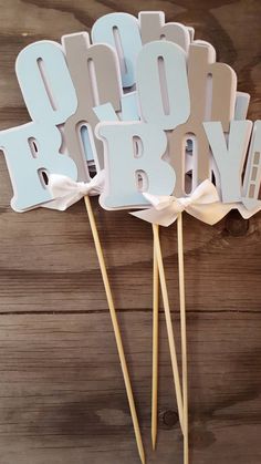 the cake toppers are made to look like baby's first birthday candles with wooden sticks