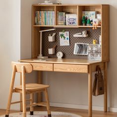 a wooden desk and chair in front of a wall with bookshelves on it