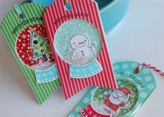 three tags with snowmen and christmas trees on them