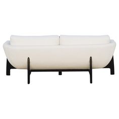 a white couch sitting on top of a wooden frame