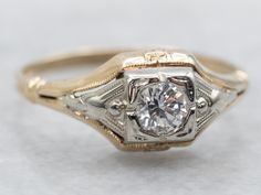 an antique diamond ring with filigrees in yellow gold and white gold setting