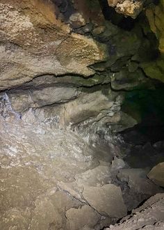 the inside of a cave with water coming out of it