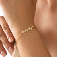 Introducing our beautiful Cross Name Bracelet, a unique and personalized piece of jewelry that combines faith and individuality. This bracelet features a delicate cross charm, symbolizing love, hope, and spiritual connection. The charm is accompanied by a customizable nameplate, where you can engrave the name of your choice. Crafted with care, this bracelet showcases a dainty design that is both elegant and meaningful. Made from high-quality materials, it ensures durability and lasting beauty. Whether it's a special gift for a loved one or a meaningful accessory for yourself, the Cross Name Bracelet is a perfect expression of faith and personal identity. It's suitable for everyday wear or to complement formal attire. Embrace the power of faith and let your name shine with this exquisite Cr Bracelet With Name, Disney Font, Personalized Cross, Bracelet Christmas, Personal Identity, Custom Bracelet, Beautiful Cross, Bracelet Display, Baptism Gifts