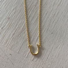 Horseshoe necklace in 14 karat gold plated over sterling silver. Length: 16-18 inch Wearing a horseshoe is about bringing good luck. Adjustable Gold Horseshoe Jewelry, Gold Horseshoe Necklace With Adjustable Chain, Gold Horseshoe Jewelry With Adjustable Chain, Gold Horseshoe Necklace For Gift, Gold Horseshoe Necklace For Good Luck, Adjustable Gold Necklace For Good Luck, Everyday Gold Horseshoe Necklace, Gold Horseshoe Charm Necklaces As Gift, Gold Horseshoe Charm Necklace As Gift