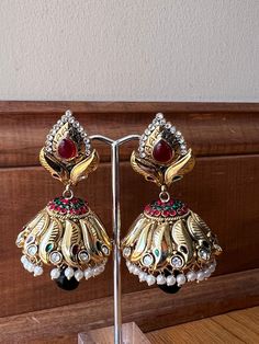 These are our beautiful indian earrings that are perfect for any occasion! Dangle Latkans Earrings For Puja, Festive Earrings With Intricate Design For Puja, Latkan Dangle Earrings For Puja, Elegant Latkans Earrings For Puja, Bollywood Style Earrings With Intricate Design For Puja, Festive Latkan Earrings For Puja, Traditional Heavy Earrings For Puja, Elegant Navratri Festive Earrings, Elegant Festive Earrings For Navratri