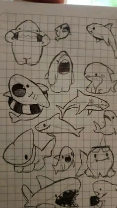 a drawing of different types of fish on a sheet of paper with graph paper in front of it