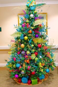 a brightly colored christmas tree decorated with ornaments